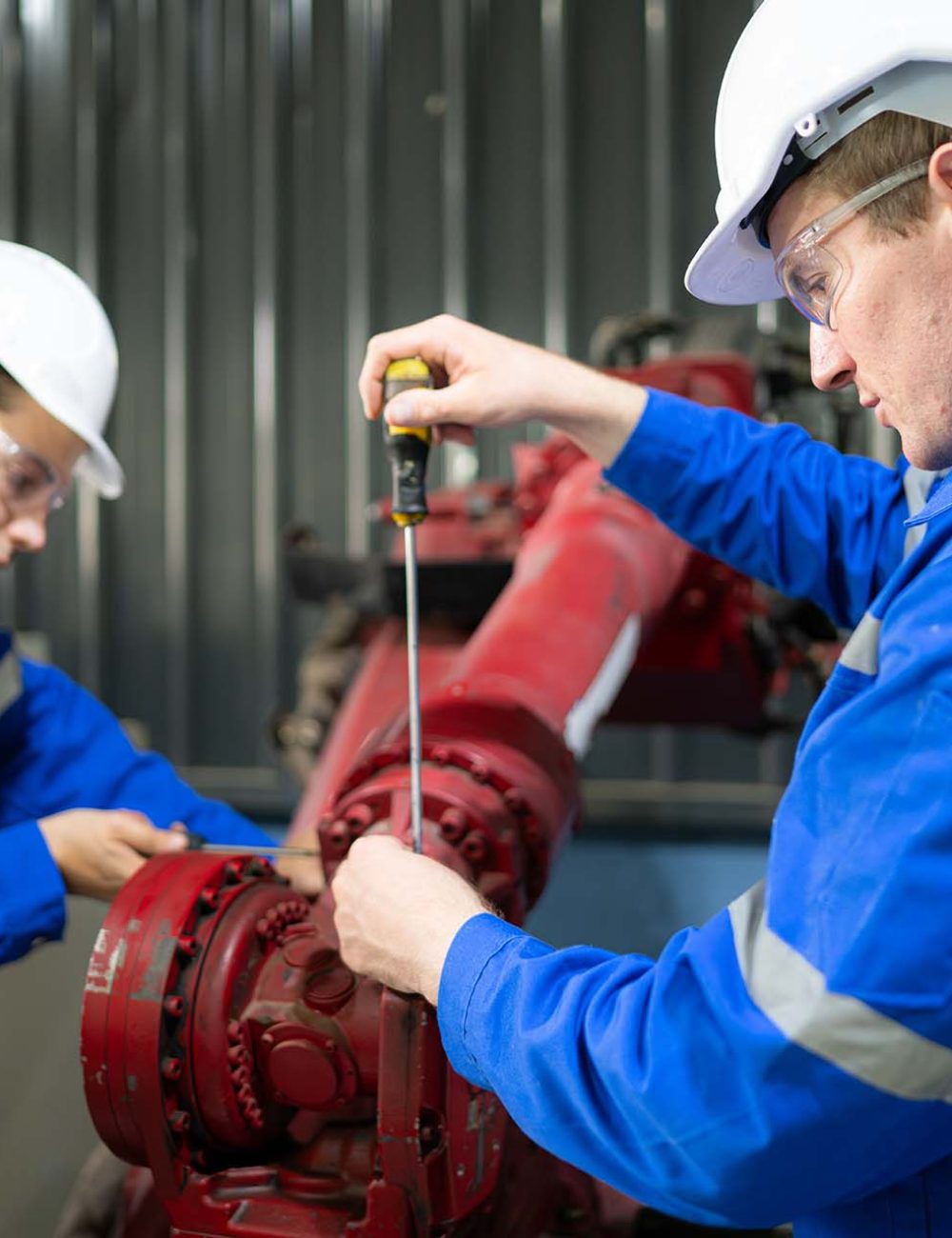 Both of engineers working together in a robotic arm factory, Robotic arm industry and engineering concept.